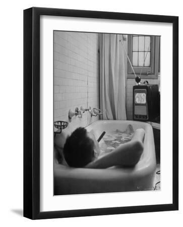 Writer Russell Finch Taking Portable Television Set to Bathroom During His Bath - Black Framed Art Print Wall Art, 12x16
